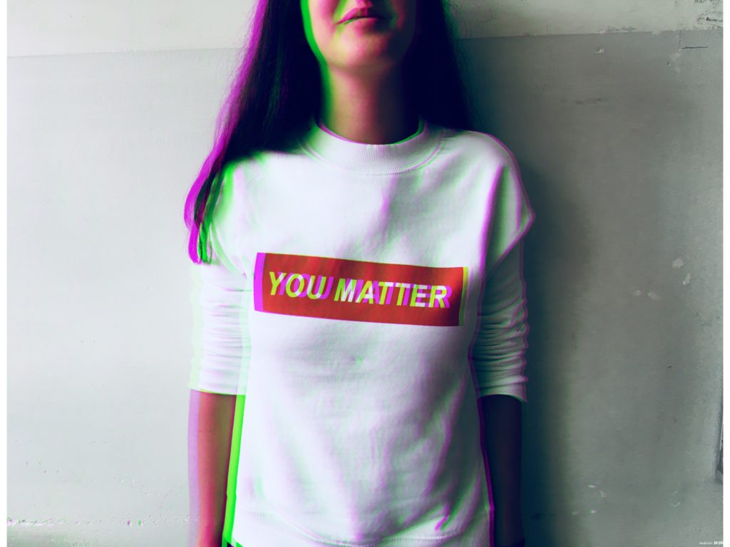 Person in a white shirt that reads "YOU MATTER".